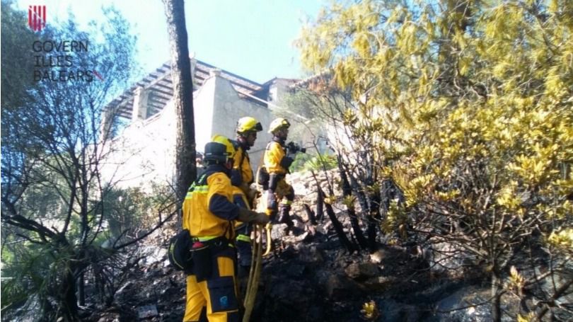 Los bomberos actúan junto a una casa