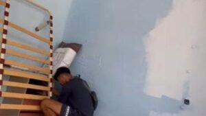 Uno de los j&oacute;venes rebuscando billetes en el narcopiso.