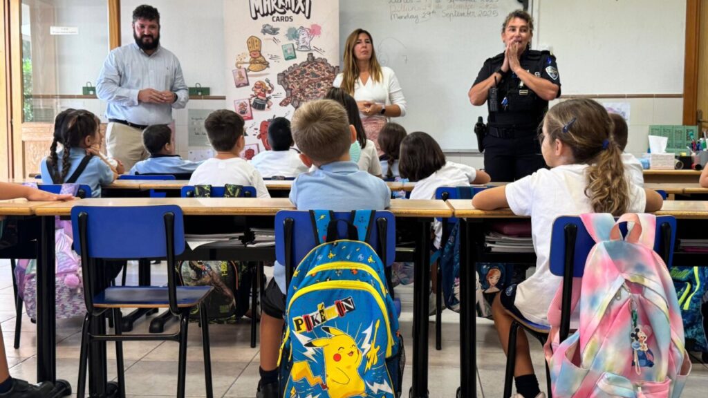 Clase de niños aprendiendo sobre Marratxí Cards con educadores y policía local.