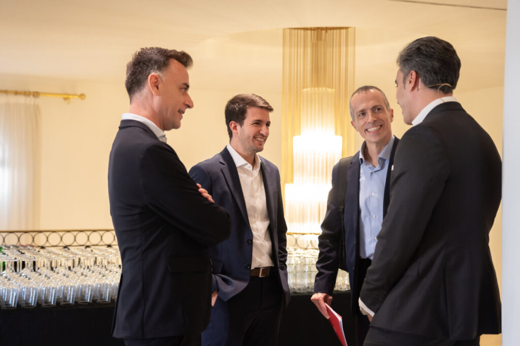 Cuatro hombres conversando en un evento de ciberseguridad
