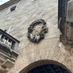 Edificio con detalles arquitectónicos y escudo en la fachada