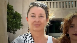 Mujer con cabello rizado y blusa blanca en un entorno exterior