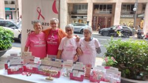 Cuatro mujeres con camisetas de Un Lazo en Movimiento en un evento.