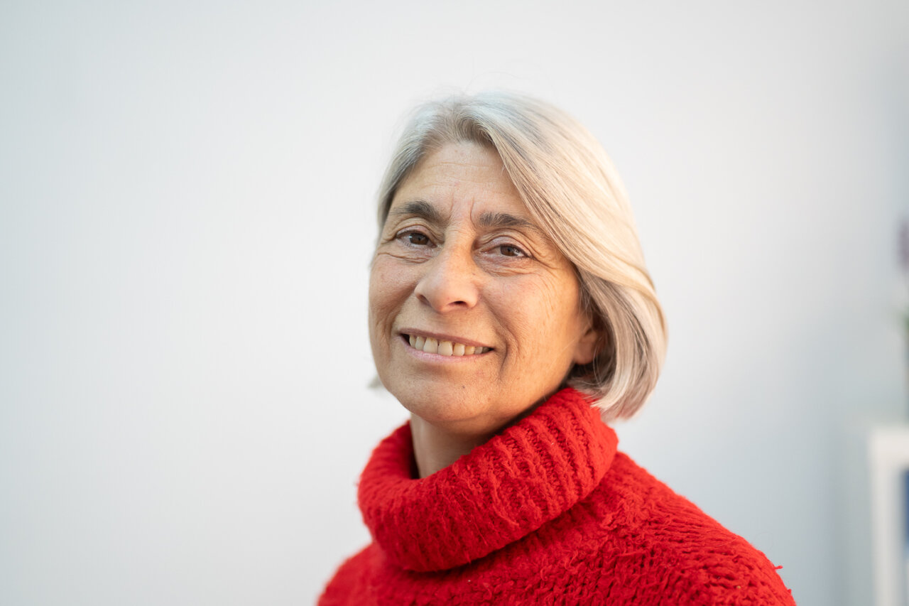 Retrato de Paz Alcoverro con suéter rojo sonriendo