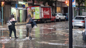 Dos personas caminando por una calle inundada en Palma.