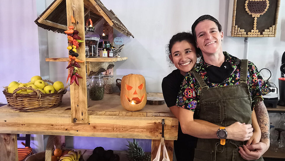Dos personas sonrientes en un café con decoración rústica