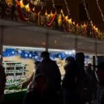 Personas visitando un mercado navideño iluminado en Mallorca
