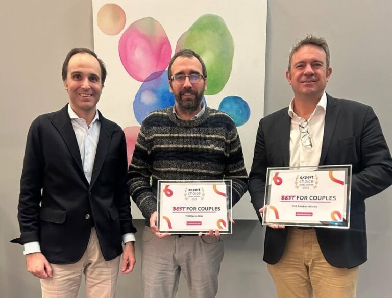 Tres hombres sosteniendo premios de reconocimiento en un evento