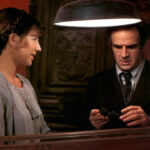 Escena de la película La habitación verde con dos personajes conversando.