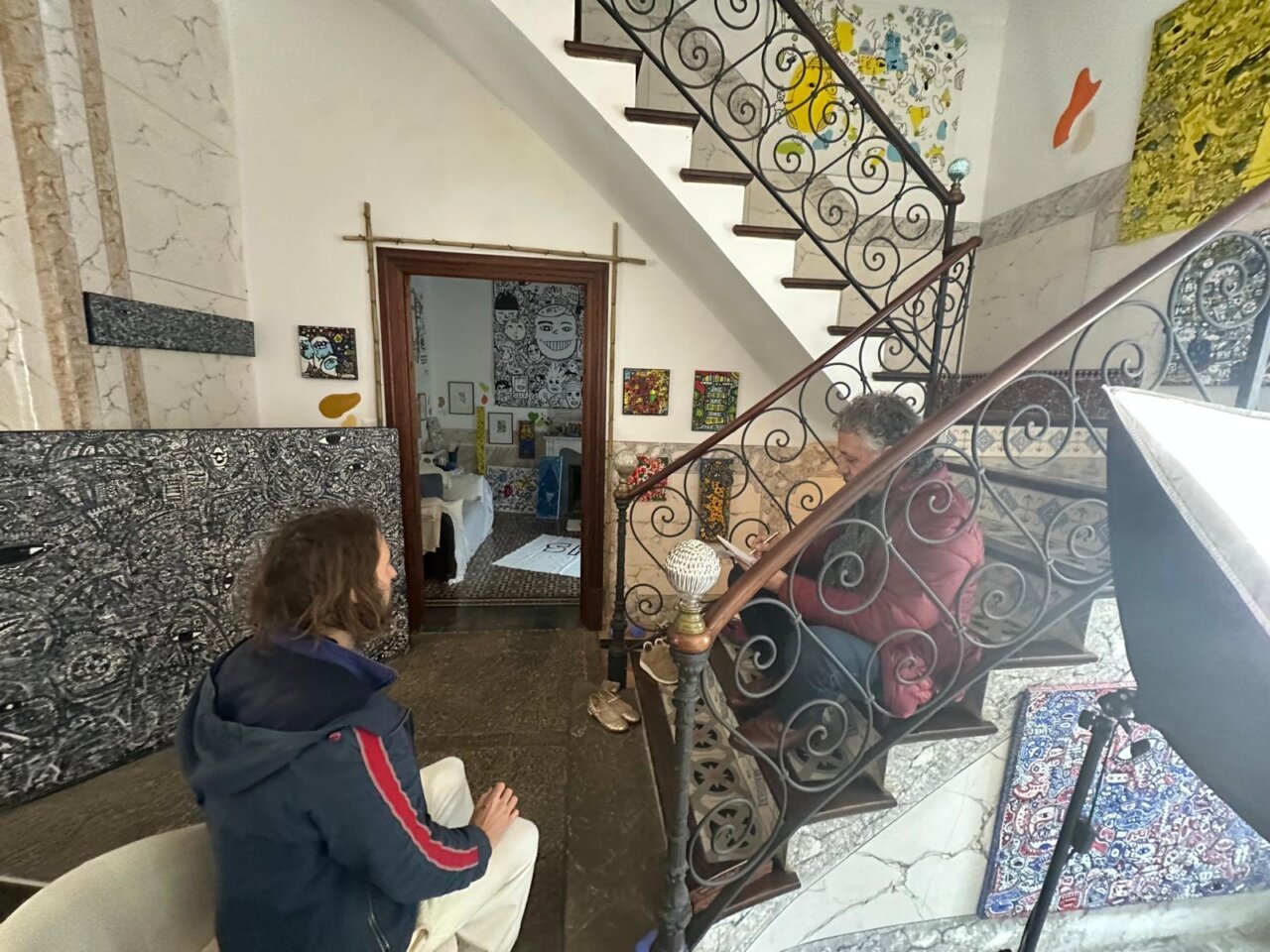 Xisco Barcel&oacute; y Space Rapha&euml;l conversando en una escalera decorada con arte.