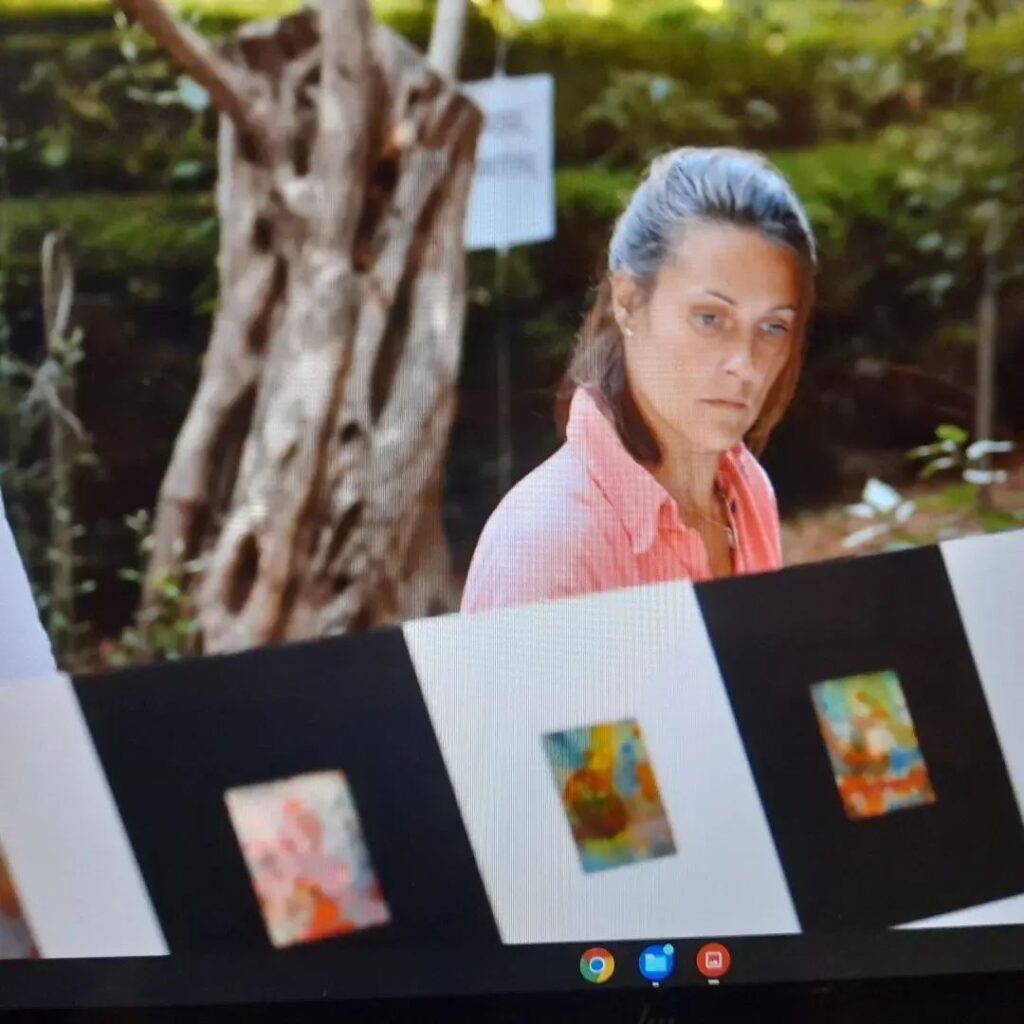 Silvina Barrera observando obras de arte en una exposici&oacute;n al aire libre