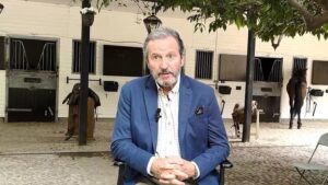 Pep Munn&eacute; sentado en un establo con caballos al fondo