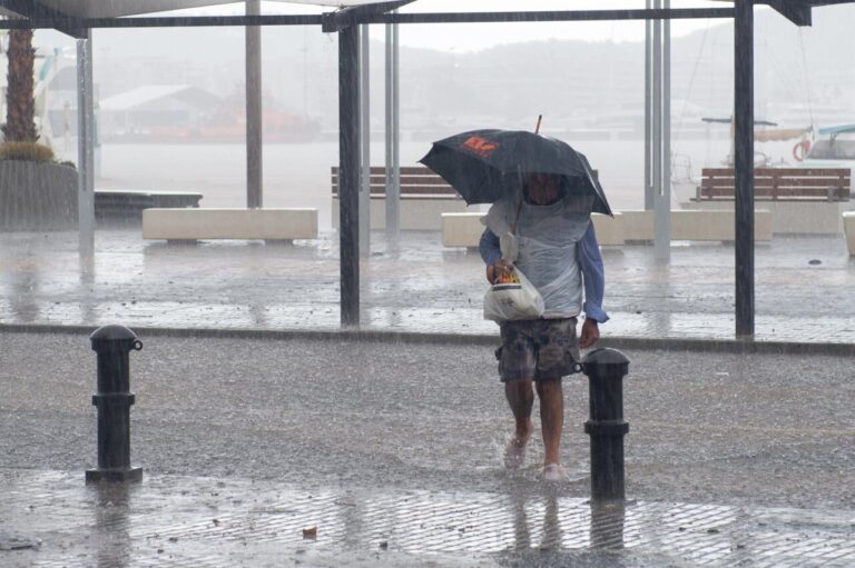 Persona caminando bajo la lluvia con paraguas en Baleares