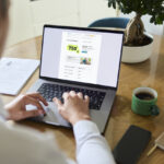 Persona usando laptop con informaci&oacute;n sobre promoci&oacute;n de Cajamar