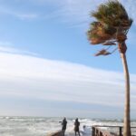 Personas observando el mar agitado por el viento fuerte en Mallorca