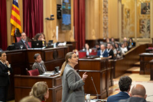 Prohens hablando en el parlamento con p&uacute;blico atento en el fondo