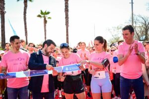Participantes en la carrera PalmaDona cortando la cinta de inicio