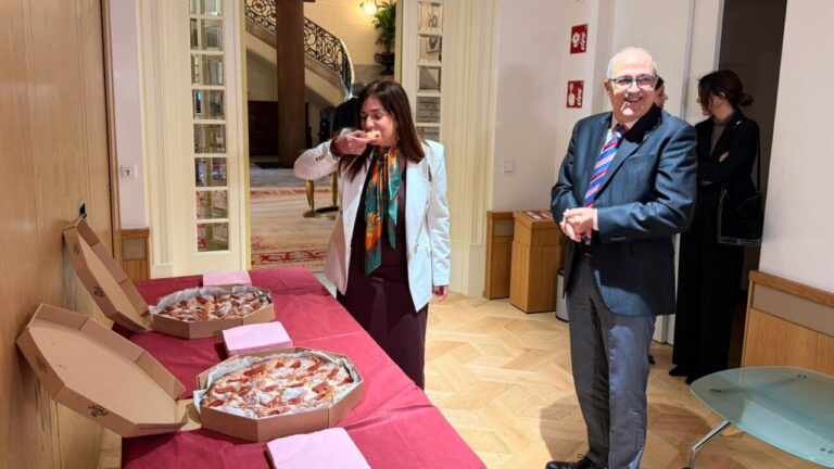 Mujer degustando ensaimada de membrillo en comisión parlamentaria