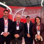 Grupo de personas en el Mobile World Congress con fondo rojo