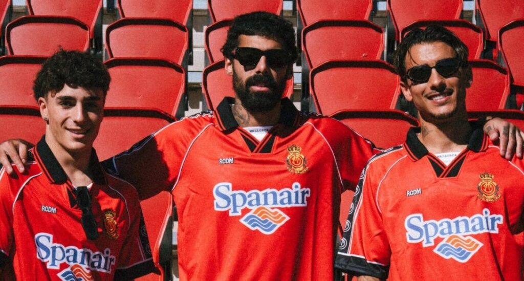 Tres jugadores posando con camisetas hist&oacute;ricas del RCD Mallorca