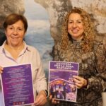 Dos mujeres sosteniendo carteles del programa del 8M en Santany&iacute;