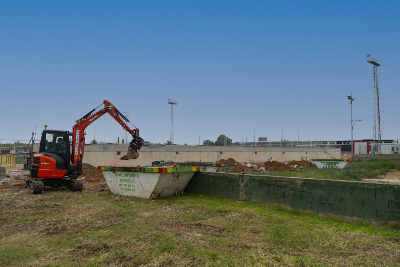 Excavadora trabajando en las obras de cubiertas en campos de fútbol