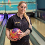 Cristina, jugadora de bolos, sosteniendo una bola en la pista.