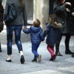 Familia caminando por la calle con ni&ntilde;os peque&ntilde;os