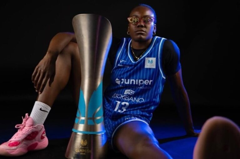 Iris Mbulito posando con un trofeo de baloncesto