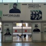 Carteles de eventos en el aeropuerto de Ibiza con artistas destacados.