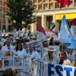 Médicos en huelga sosteniendo pancartas y banderas en una manifestación