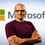 Satya Nadella, CEO de Microsoft, con el logo de la empresa detr&aacute;s.