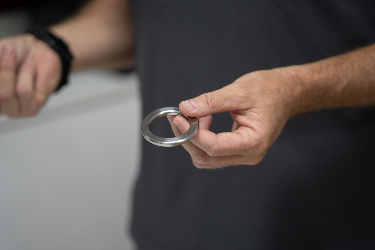 Persona sosteniendo un anillo metálico en la mano