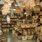 Interior de una tienda de mimbrería con cestas y sombreros