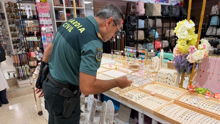 Agente de la Guardia Civil revisando joyas falsificadas en una tienda