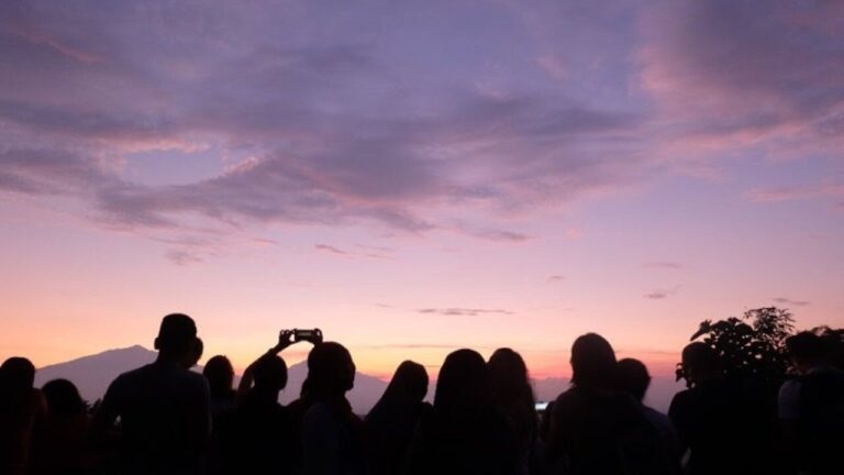 Personas observando un atardecer mientras esperan un eclipse solar