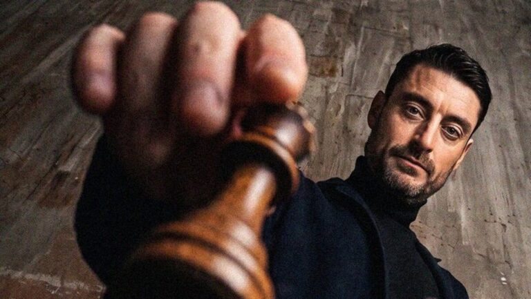 Albert Riera sosteniendo una pieza de ajedrez con fondo neutro